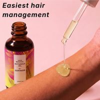 Dropper releasing Corvasse oil onto a forearm for easy hair management